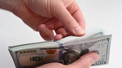 Hands counting thick stack of hundred dollar bills on white background in c.. Stock Footage 339383142