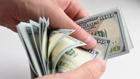 Hands counting thick stack of one hundred dollar bills in slow motion. Stock Footage 339398547
