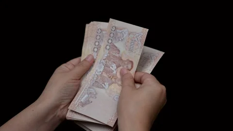 Hands counting of thousands Thai baht banknotes money on black background. Stock Footage 233270778