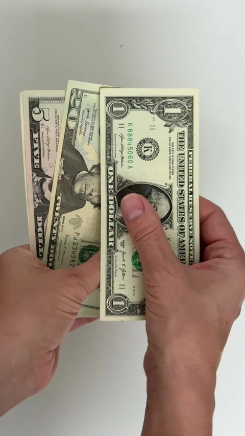 Hands Counting US Dollar Banknotes on White Background Vertical Stock Footage 340649756