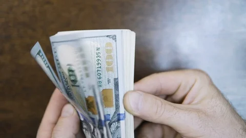 Hands counting US Dollar bills or paying in cash on money background. Stock Footage 123153530