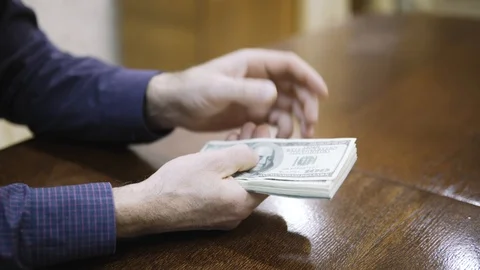 Hands counting US Dollar bills or paying in cash on money background. Stock Footage 123153651