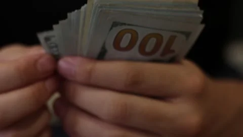 Hands counting US Dollar bills or paying in cash on money background. Stock Footage 137124929