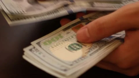 Hands counting US Dollar bills or paying in cash on money background. Stock Footage 139778466
