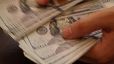 Hands counting US Dollar bills or paying in cash on money background. Stock Footage 139779339