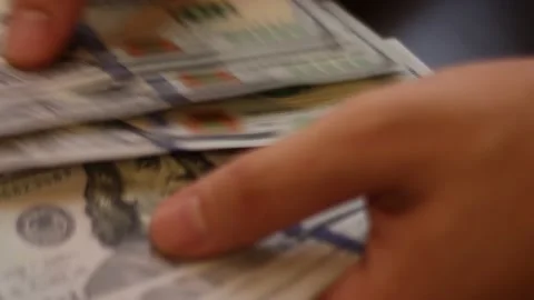 Hands counting US Dollar bills or paying in cash on money background. Stock Footage 139782039