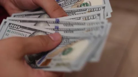 Hands counting US Dollar bills or paying in cash on money background. Stock Footage 143110508