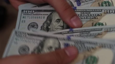 Hands counting US Dollar bills or paying in cash on money background. Stock Footage 143116096