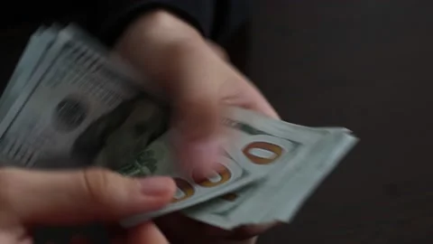 Hands counting US Dollar bills or paying in cash on money background. Stock Footage 150208635