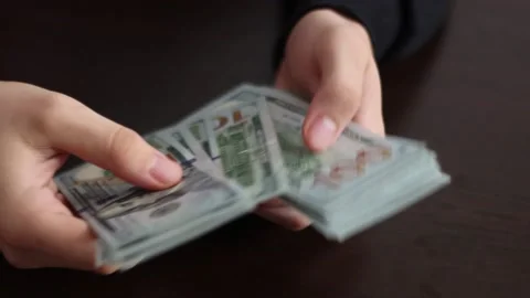 Hands counting US Dollar bills or paying in cash on money background. Stock Footage 150209513