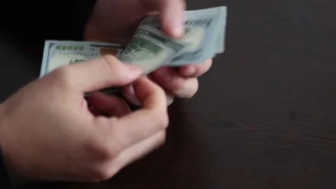 Hands counting US Dollar bills or paying in cash on money background. Stock Footage 150209779