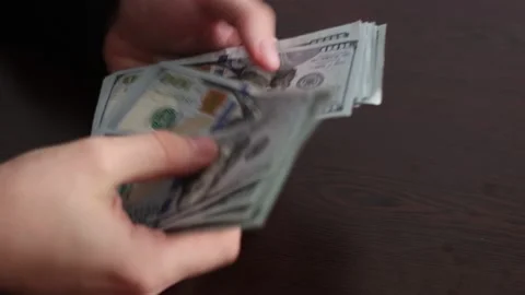 Hands counting US Dollar bills or paying in cash on money background. Stock Footage 150212237