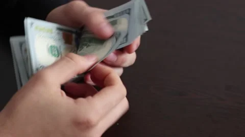 Hands counting US Dollar bills or paying in cash on money background. Stock Footage 150212662