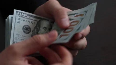 Hands counting US Dollar bills or paying in cash on money background. Stock Footage 150214136