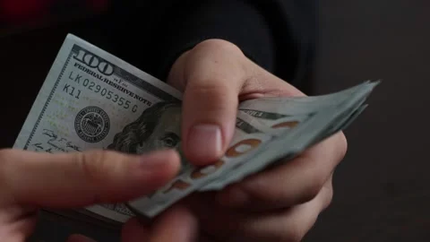 Hands counting US Dollar bills or paying in cash on money background. Stock Footage 150214170
