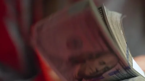 Hands counting US Dollar bills or paying in cash against the backdrop of police Stock Footage 176580432