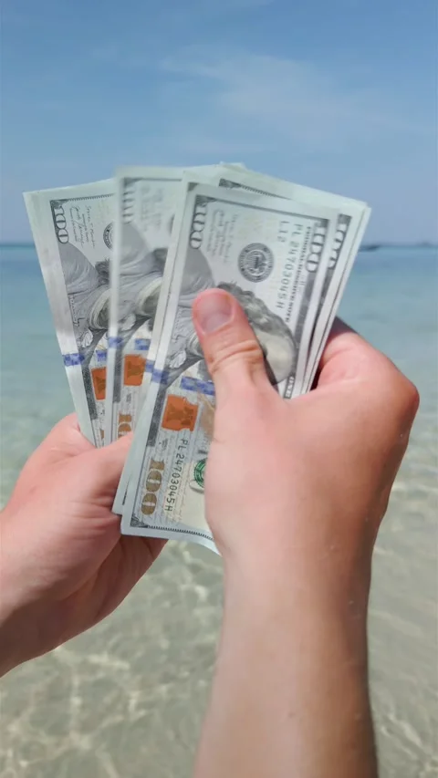 Hands counting US dollars on tropical beach. Close up Stock Footage 258809727