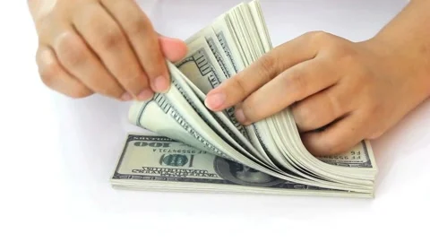 Hands counts dollar bills on a table on a white background, close-up view. Stock-Footage 336264527