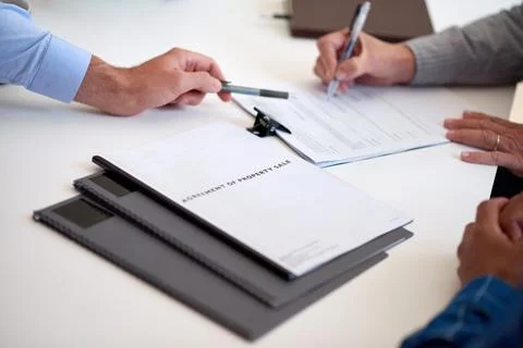 Hands, couple and agent with pointing for signature, insurance agency or policy Fotos de archivo