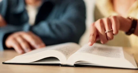 Hands, couple and reading in home with bible, study scripture and morning prayer Stock-Footage 337015444