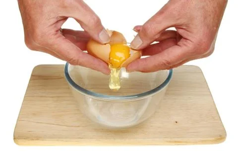 Hands cracking egg Stock Photos