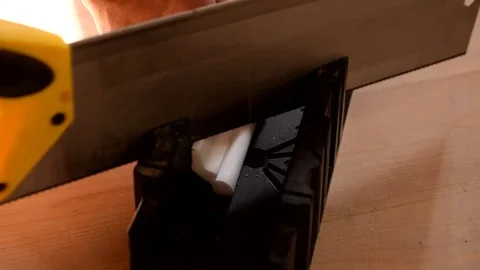 Hands of a craftsman cutting a white ceiling molding Stock Footage 71313306