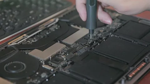 Hands of a craftsman use an electronic screwdriver to unscrew internal Stock Footage 335560475