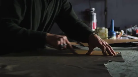 The hands of a craftsman work the made in italy leather Video stock 223885161