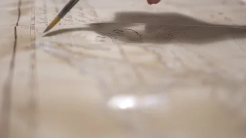 Hands create aged map with paint brush and white watercolor, close-up Stock-Footage 94768286