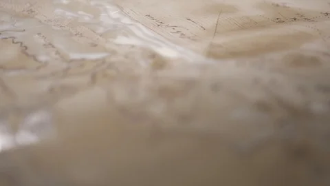 Hands create aged map with paint brush and white watercolor, close-up Stock-Footage 94768297