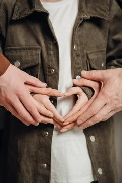 Hands create heart shape showing love and connection among people Stock Photos