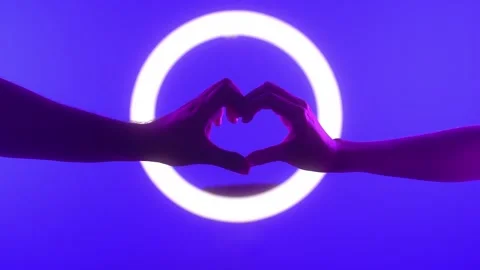 Hands Creating Heart Shape with Neon Circle in Background Stock Footage 313283083