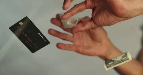 Hands, credit card and lines with addiction, drugs and bag with money for Stock Footage 285942265