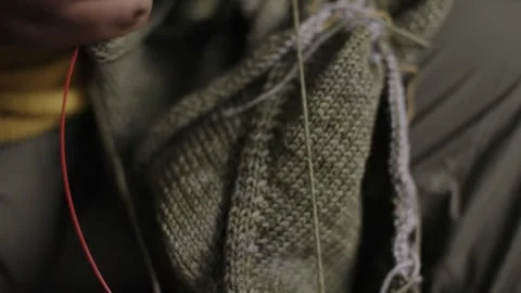 Hands Crocheting Green Garment as Camera Pans Across Fabric Detail Stock-Footage 323947188