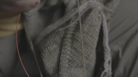 Hands Crocheting Green Garment as Camera Pans Across Fabric Detail Stock-Footage 323947189