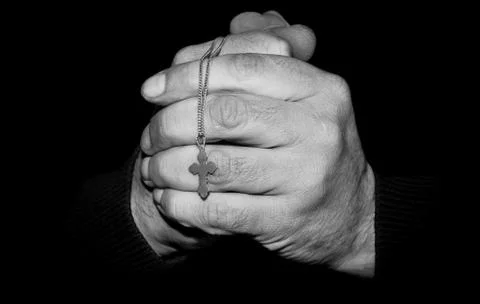 Hands with a cross Stock Photos