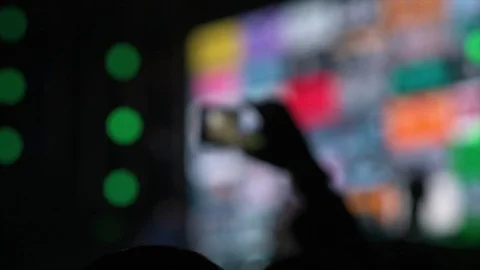 Hands in the crowd holding smart phone and shooting musical performance. Bright Stockbeeldmateriaal 87846496