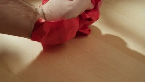 Hands crumpling red paper close-up. Macro shooting of crumpled sheet. Vídeo Stock 169236925