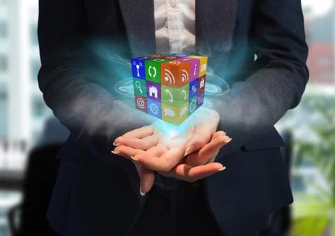 Hands with cube of application icons with blue lights Stock Photos