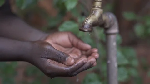 Hands Cupped under Water Tap Stock Footage 98633738