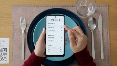Hand's customer scan QR code for online menu service at table in restaurant Stock Footage 146328391