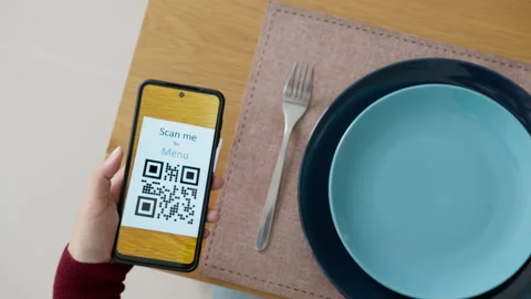 Hand's customer scan QR code for online menu service at table in restaurant Stock Footage 146328912