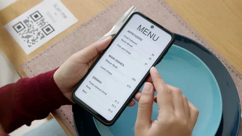 Hand's customer scan QR code for online menu service at table in restaurant Stock Footage 146329589
