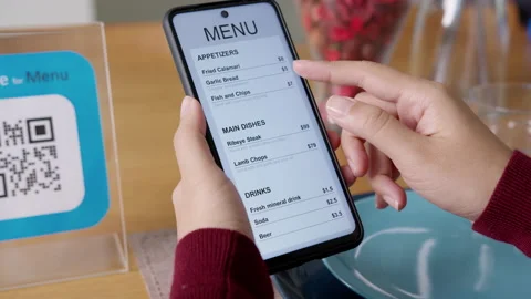 Hand's customer scan QR code for online menu service at table in restaurant Stock Footage 146329617