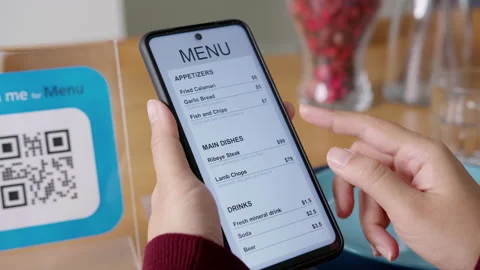 Hand's customer scan QR code for online menu service at table in restaurant Stock Footage 146329642