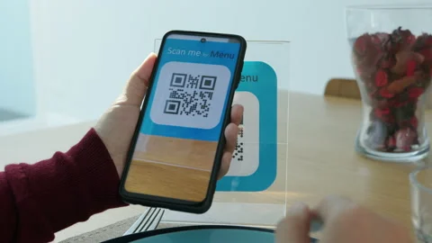 Hand's customer scan QR code for online menu service at table in restaurant Stock Footage 146329678