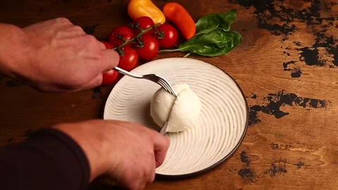Hands cut a ball of mozzarella Stock Footage 166944344