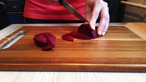 Hands cut beets into thin slices. Closeup. Stock Footage 255117510