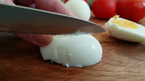 Hands cut boiled egg Stock Footage 93487588