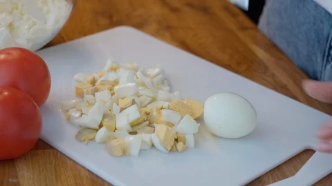 Hands cut boiled egg for salad Stock Footage 127215687